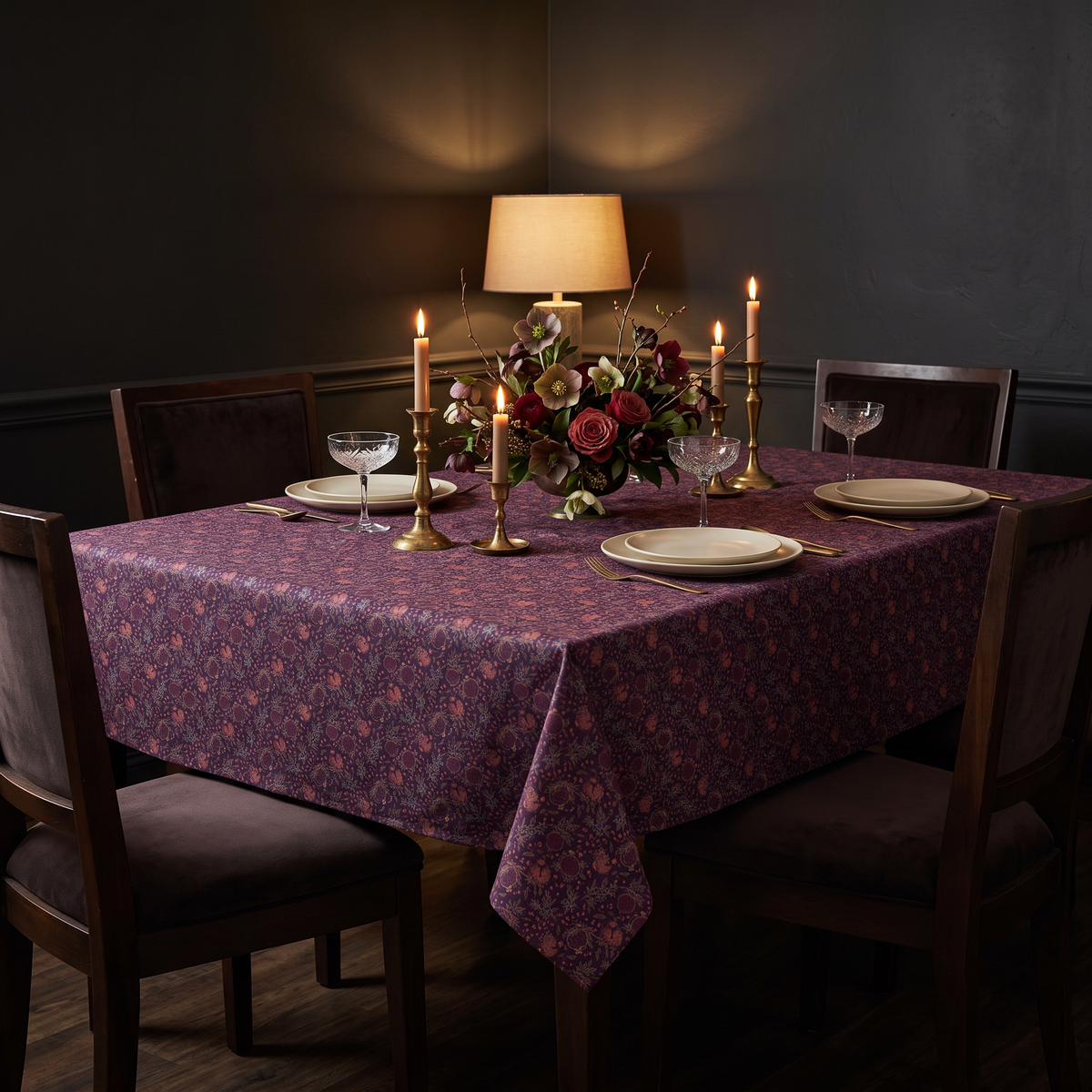 Deco Tablecloth covering a square dining table set for four with candles and coupe glasses